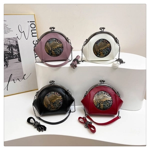 Detail of vintage shell bags with elephant metal ornaments and chain straps