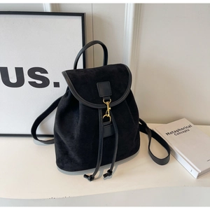 Detail of minimalist black matte backpack with metal buckle and drawstring closure
