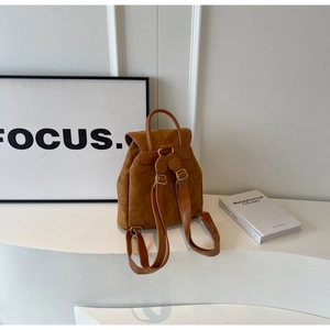 Rear view of caramel suede backpack with leather straps and gold hardware for daily travel