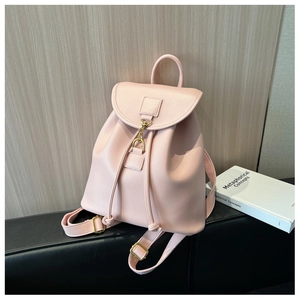 Detail of pink leather backpack with drawstring closure and vintage gold buckles