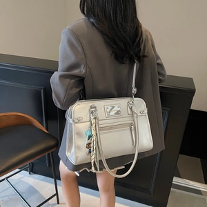 Silver metallic large tote bag for women showing a stylish shoulder carry on a model