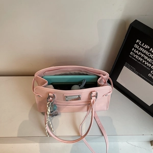 Pink minimalist leather tote bag showing large capacity for tablet and essentials