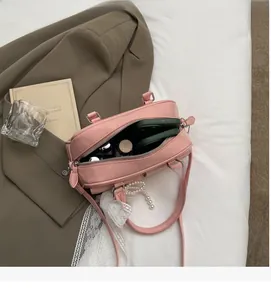 Top view of pink Boston bag showing spacious interior with phone and cosmetics