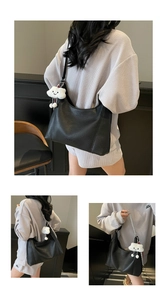 Detail of black lychee grain Hobo tote bag with metal chain and plush cloud charm