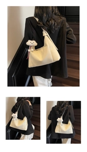 Detail of creamy white pebble leather hobo bag with knotted strap and cloud pendant