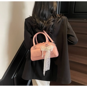 Pink pillow bag for women featuring white lace bow and elegant pearl charm detail