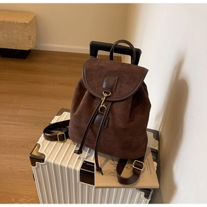 Detail of suede leather backpack with drawstring closure and bronze metal hook buckle