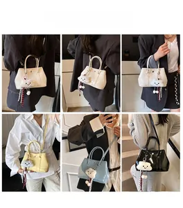 Detail view of stylish tote bags in various colors with cute cloud pendants and straps