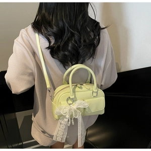 Detail of mint green pillow bag with lace bow pendant and pearl charm decoration