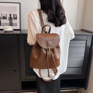 Brown faux leather drawstring backpack for women with flap cover and gold metal hook