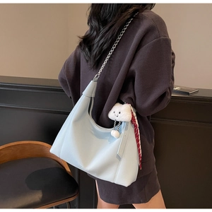 Detail of light blue lychee pattern tote bag with cloud charm and decorative scarf