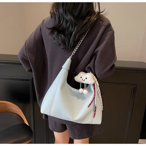 Light blue pebbled leather tote bag with silver chain strap and cloud charm detail
