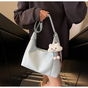 Detail of light blue lychee texture tote bag with chain strap and cloud charm