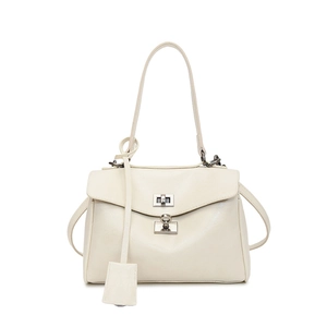 Detail of cream white leather handbag featuring vintage silver metal twist lock and texture