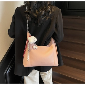 Detailed back view of pink lychee leather hobo bag with cloud charm and chain strap
