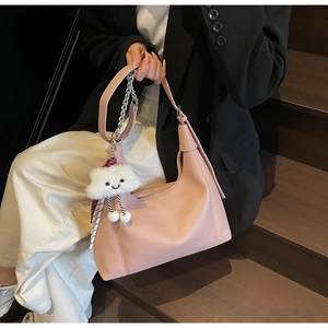 Pink lychee texture hobo bag detail with silver chain and white cloud plush charm