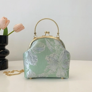 Elegant light green satin handbag with silver floral embroidery and golden metal handle