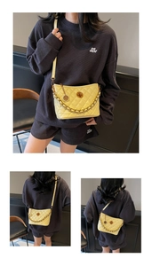 Detailed view of pale yellow quilted crossbody bag with gold chain and metal twist lock