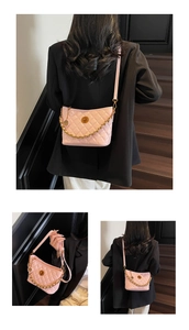 Detail of pink quilted tote bag showing golden chain and textured faux leather finish