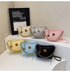 Quilted bucket bags set in six colors with gold chain straps and metal twist locks