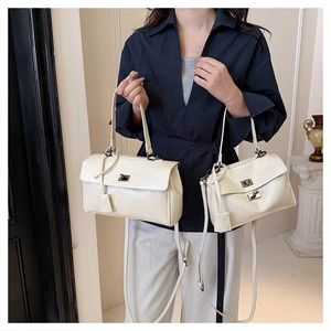 Detail view of large and small off-white crossbody bags with metal twist locks
