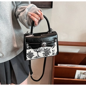 Close-up of retro Kelly bag with rabbit illustration and silver twist lock detail
