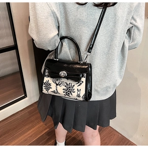 Detail of vintage bunny print bag with black leather flap and silver rotary lock