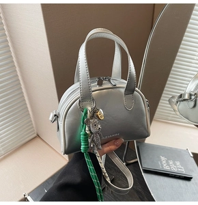 Detail of silver metallic handbag with dual handles and AZIANDI embossed branding