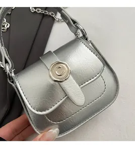 Detailed close-up of a silver mini bag featuring a signature C metal wax seal buckle