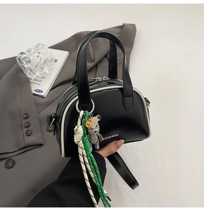 Detail of black semi-circular crossbody bag with contrast white piping and AZIANDI logo