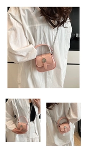 Detail of pink mini square bag with glossy patent leather and silver chain strap