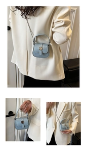 Detail view of mini light blue PU leather chain bag with round metal buckle and handle