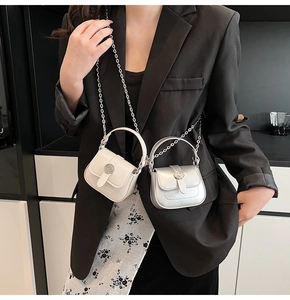 Detail of mini saddle bags in cream white and metallic silver with sunburst magnetic buckles