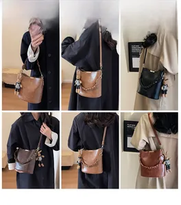 Detailed views of vintage bucket bag with woven handle and plush bunny pendant on model