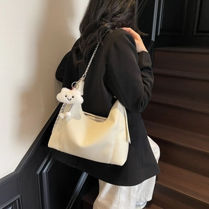 Chic off-white lychee grain leather hobo bag with silver chain and plush cloud charm