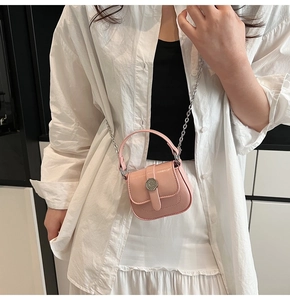 Detail of pink micro crossbody bag with glossy finish and silver C logo on the metal buckle