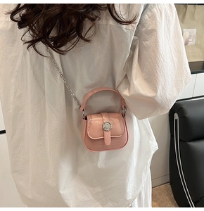 Pink mini square bag with silver chain and C-logo buckle shown on a model