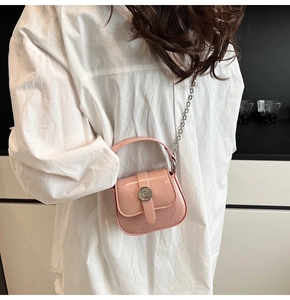 Detailed back view of a pink patent leather mini square bag with silver chain strap