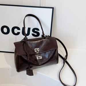 Deep coffee brown vintage hobo bag with double metal locks and oil-wax leather texture