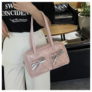Detail of pink glossy leather tote with silver bow knots and dual shoulder straps