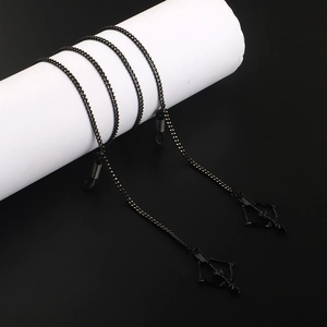 Black metal eyeglasses chain with bow and arrow pendant on a display stand