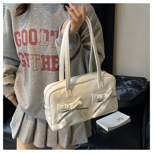 Detail of white PU leather tote with pleated pockets and silver bow decorations