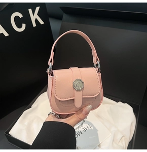 Detail of mini pink PU leather crossbody bag with silver C-logo buckle and chain