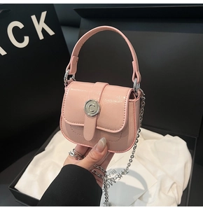Detailed view of pink mini handbag with shiny crinkled leather and silver petal buckle