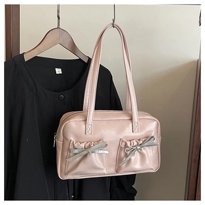 Detail of pink faux leather tote with silver bow ties and ruched front double pockets