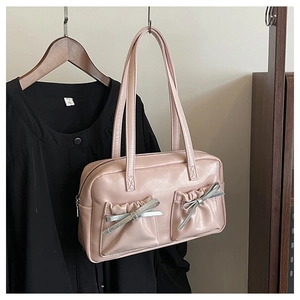 Detail of pink PU leather tote with pleated pockets and silver bow decorations