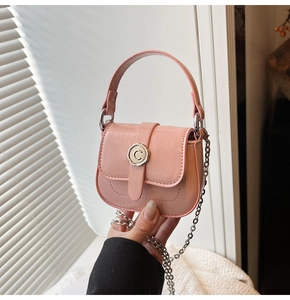 Detail view of pink mini bag with soft leather texture and silver letter C metal clasp