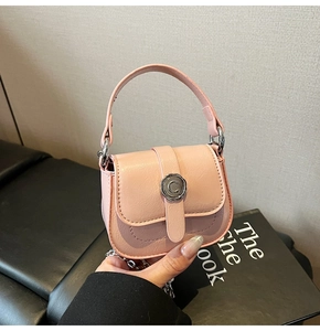 Detail of pink mini square bag with pebble grain texture and silver metal C logo buckle
