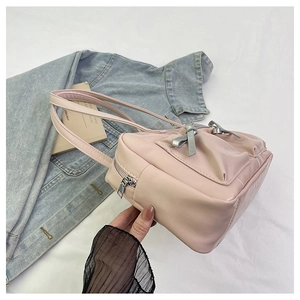 Close-up of pink bow tote bag with metallic zipper and premium PU leather texture