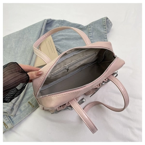 Close-up of pink tote bag interior showing zipper pockets and spacious storage space